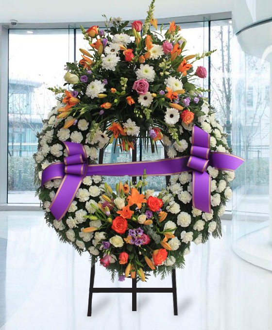 Corona funeraria de clavel de rosas naranjas en Gijón